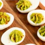 Top down view of deviled eggs with avocado.