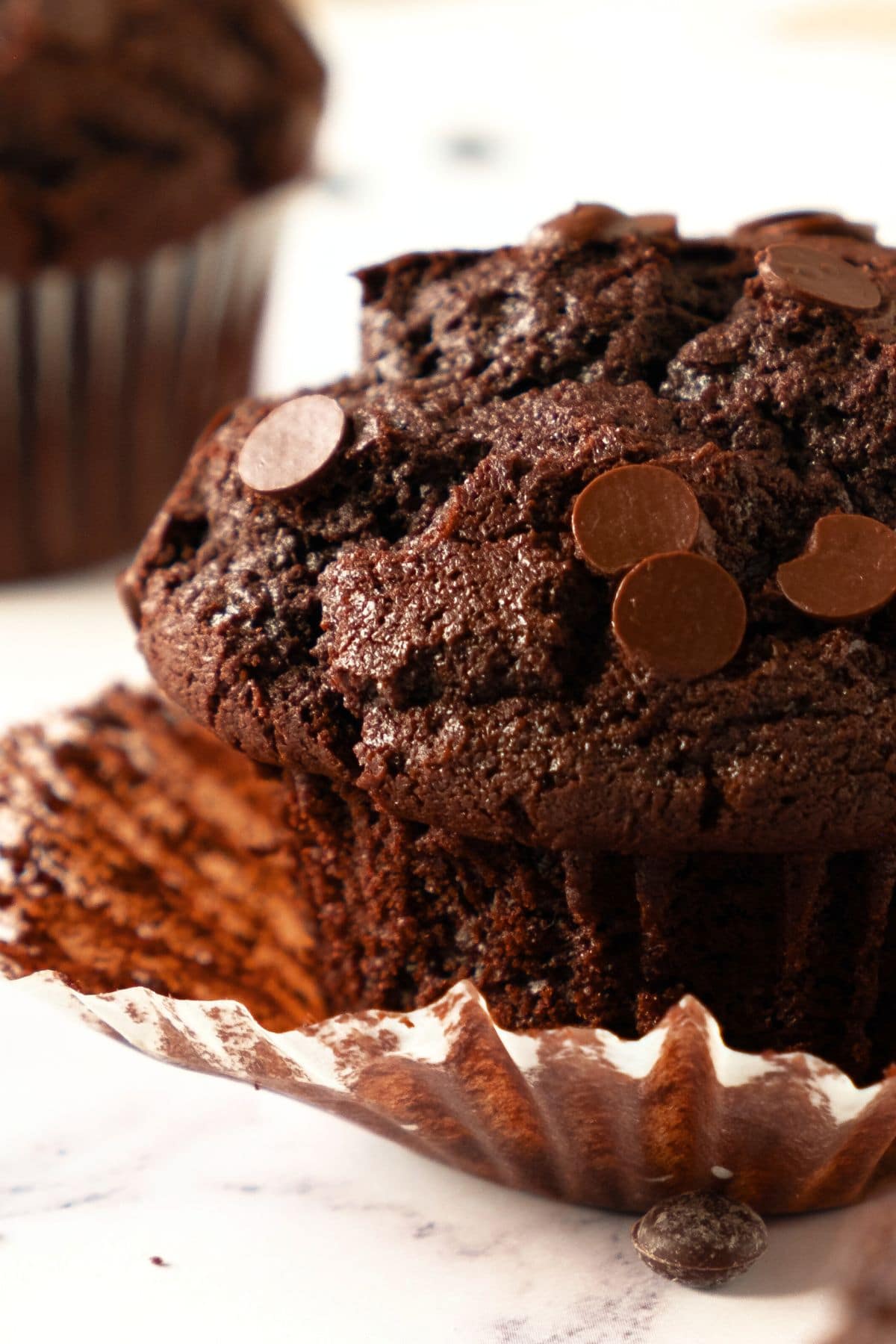 Up close view of a gf chocolate muffin and paper liner.