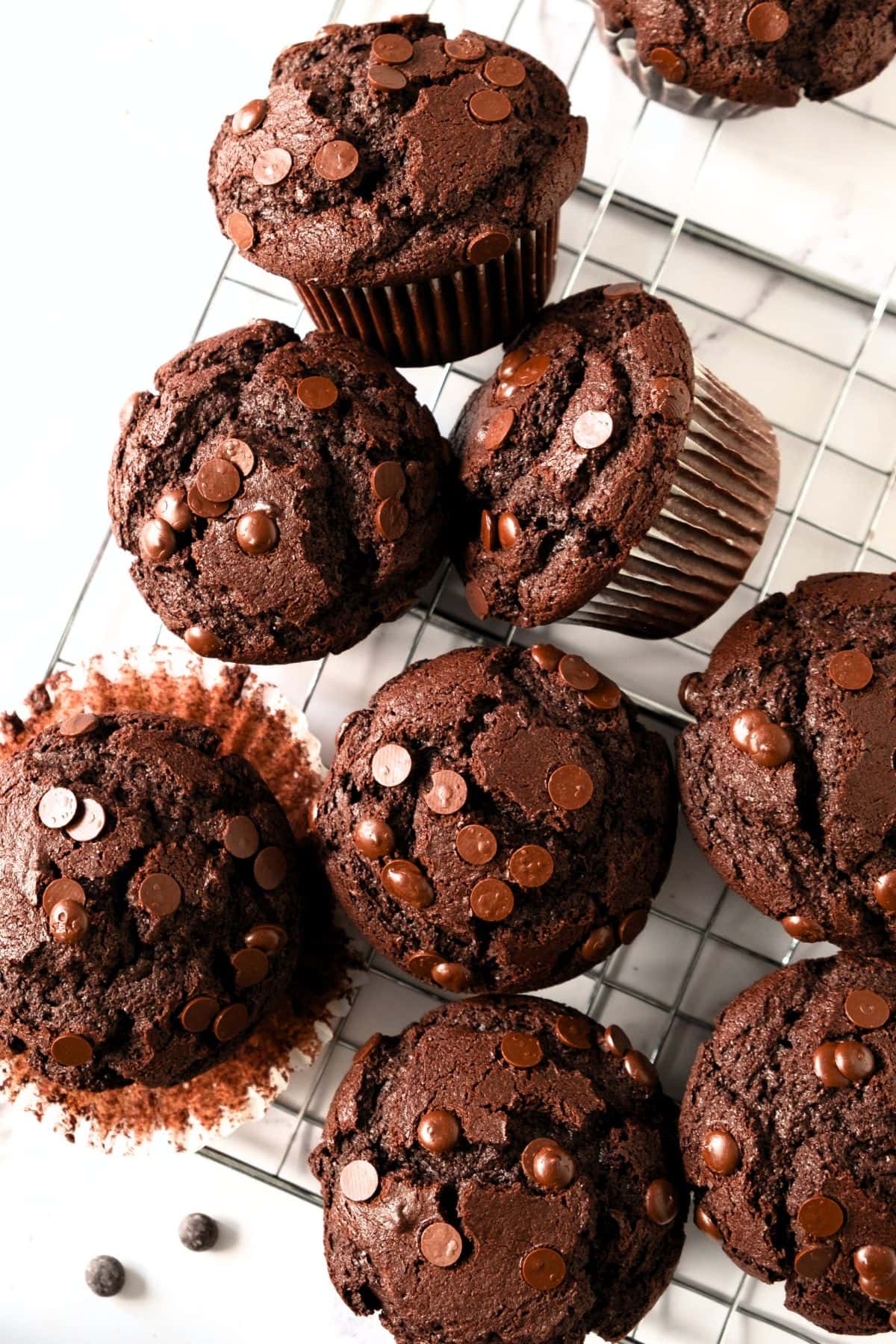Top down view of gluten-free chocolate muffins on wire rack.