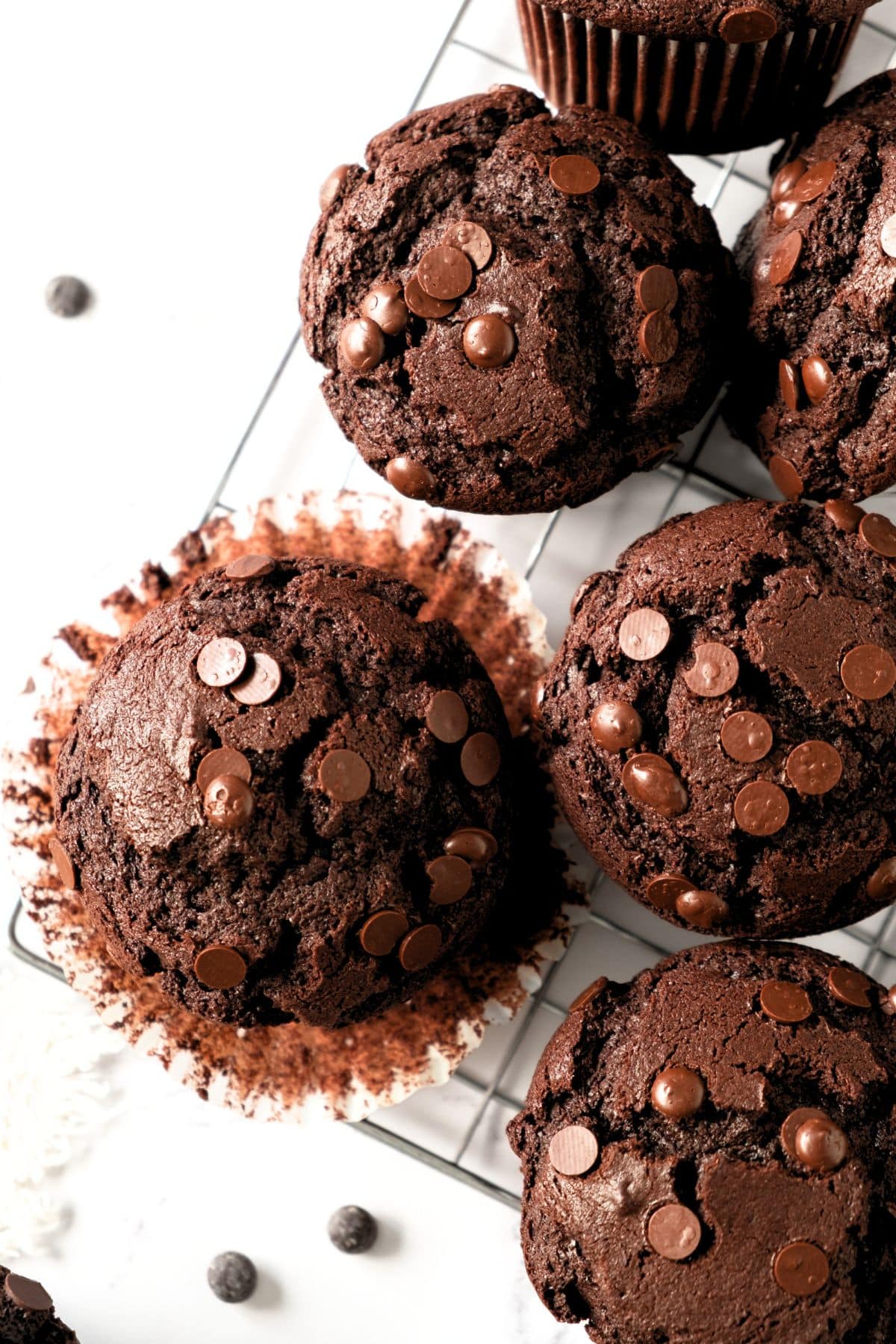 Up close view of chocolate chip muffins on wire rack.