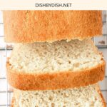 Sliced loaf of bread on cooling rack.