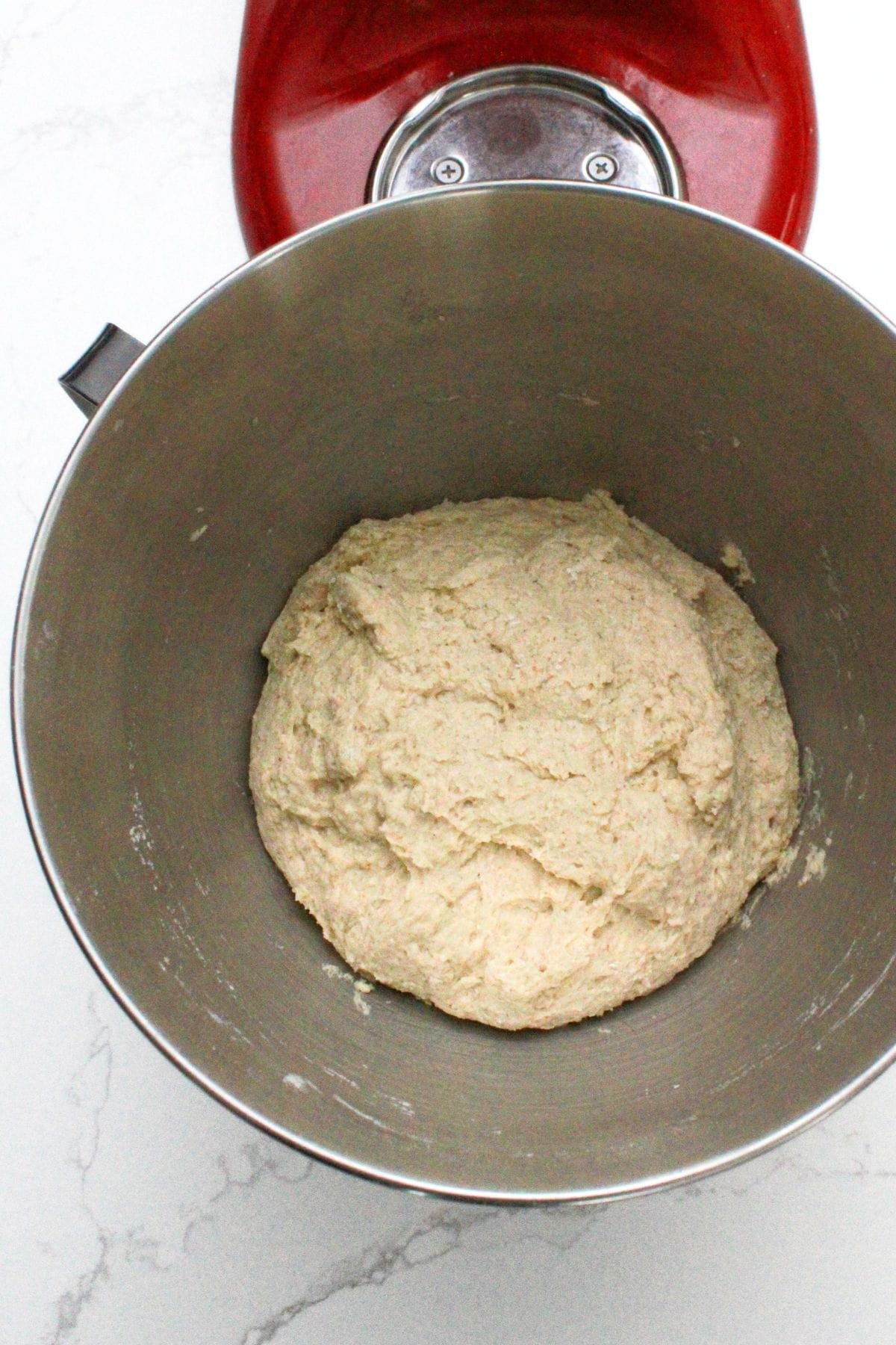 English muffin dough in metal bowl