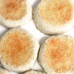 Top down view of freshly cooked English muffins on plate