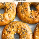 Top down view of gluten-free everything bagels on parchment paper