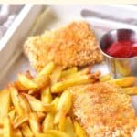 Fish and chips in white tray.