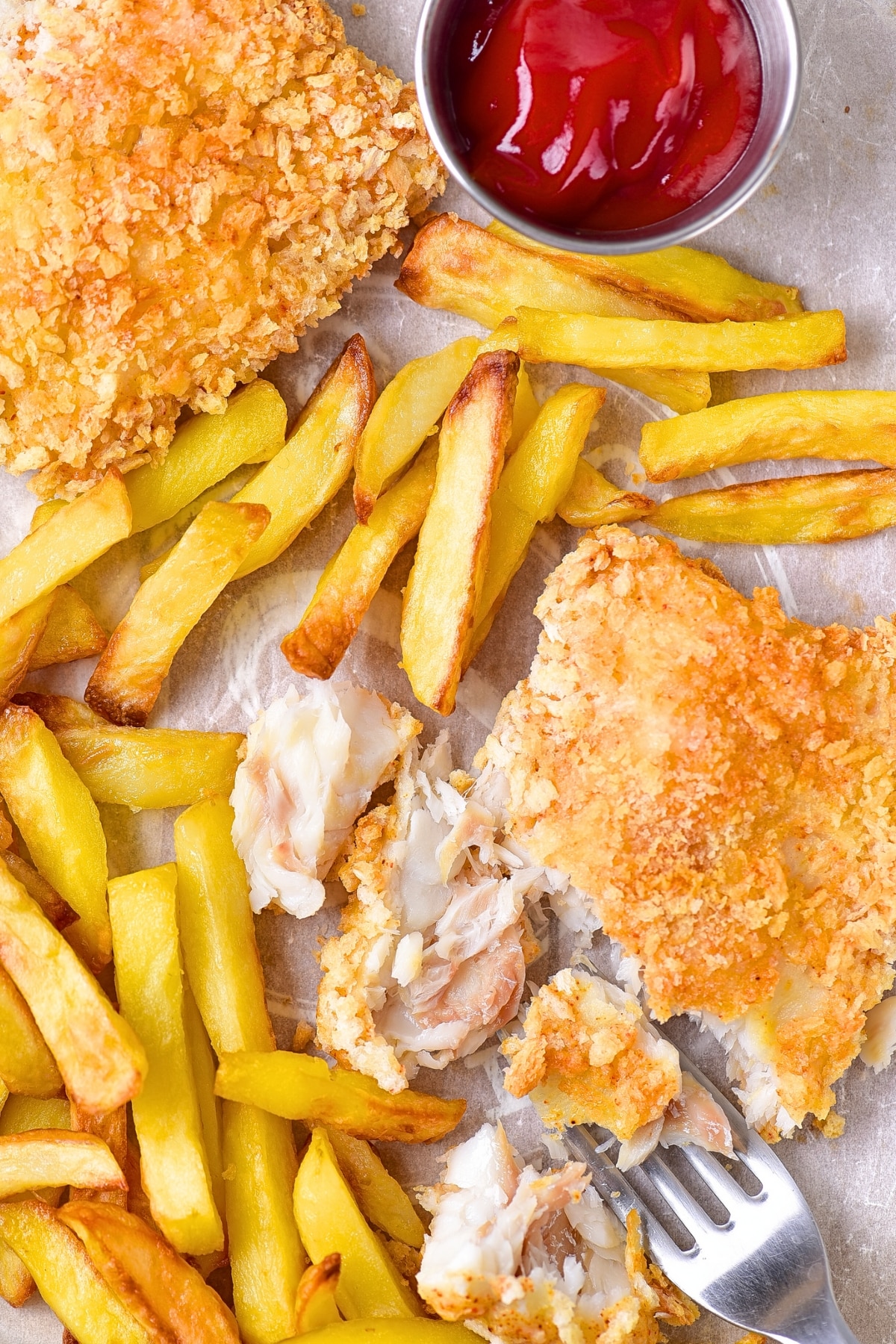 Top down view of half-eaten fish and chips