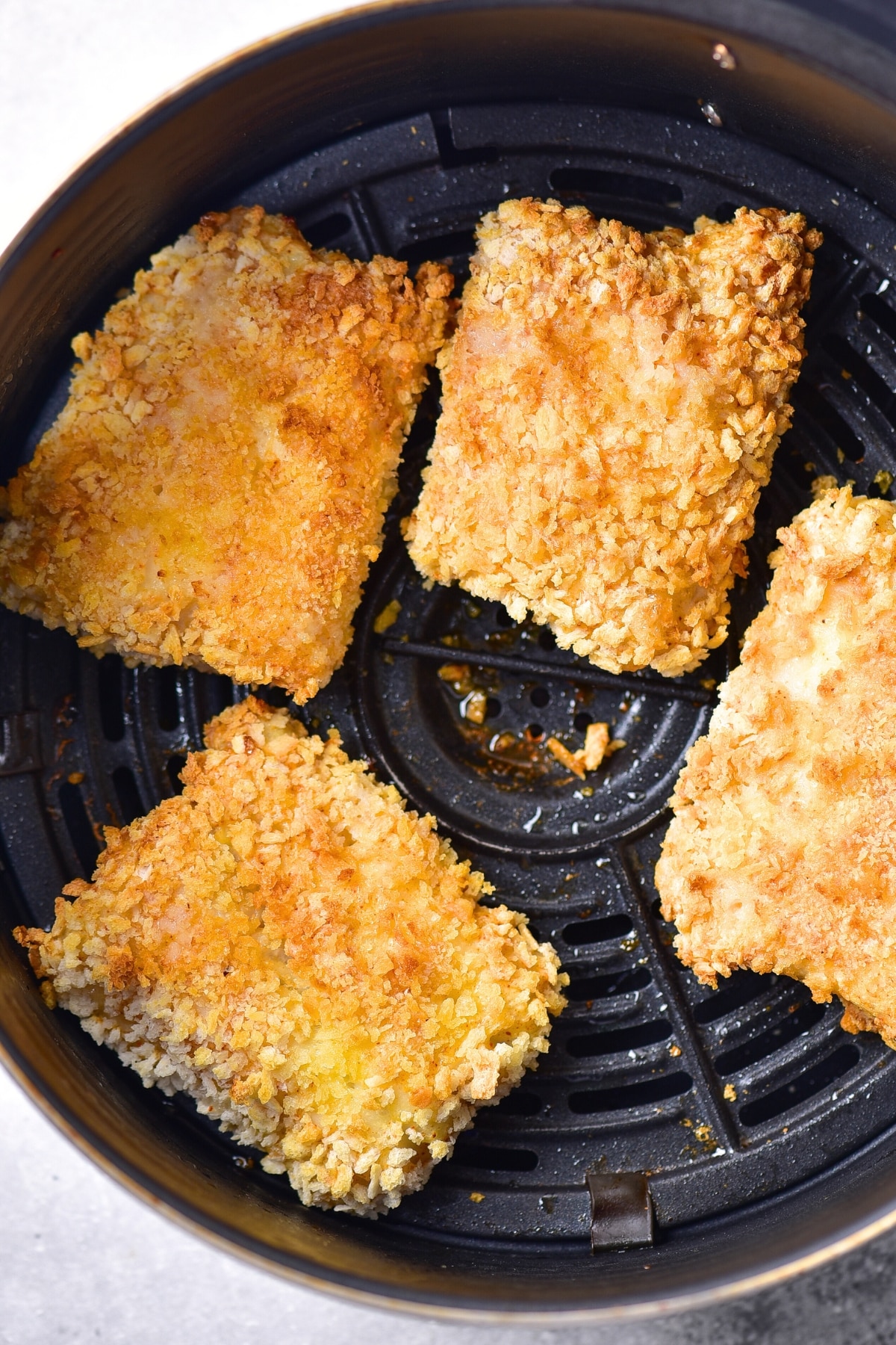 Cooking gluten-free fish and chips in air fryer.