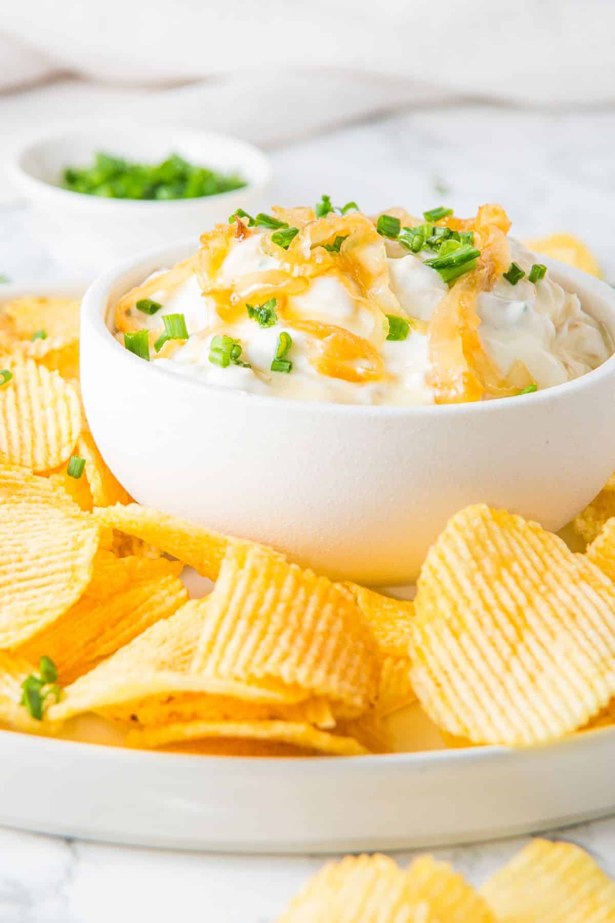 A plate of potato chips and gluten-free French onion dip