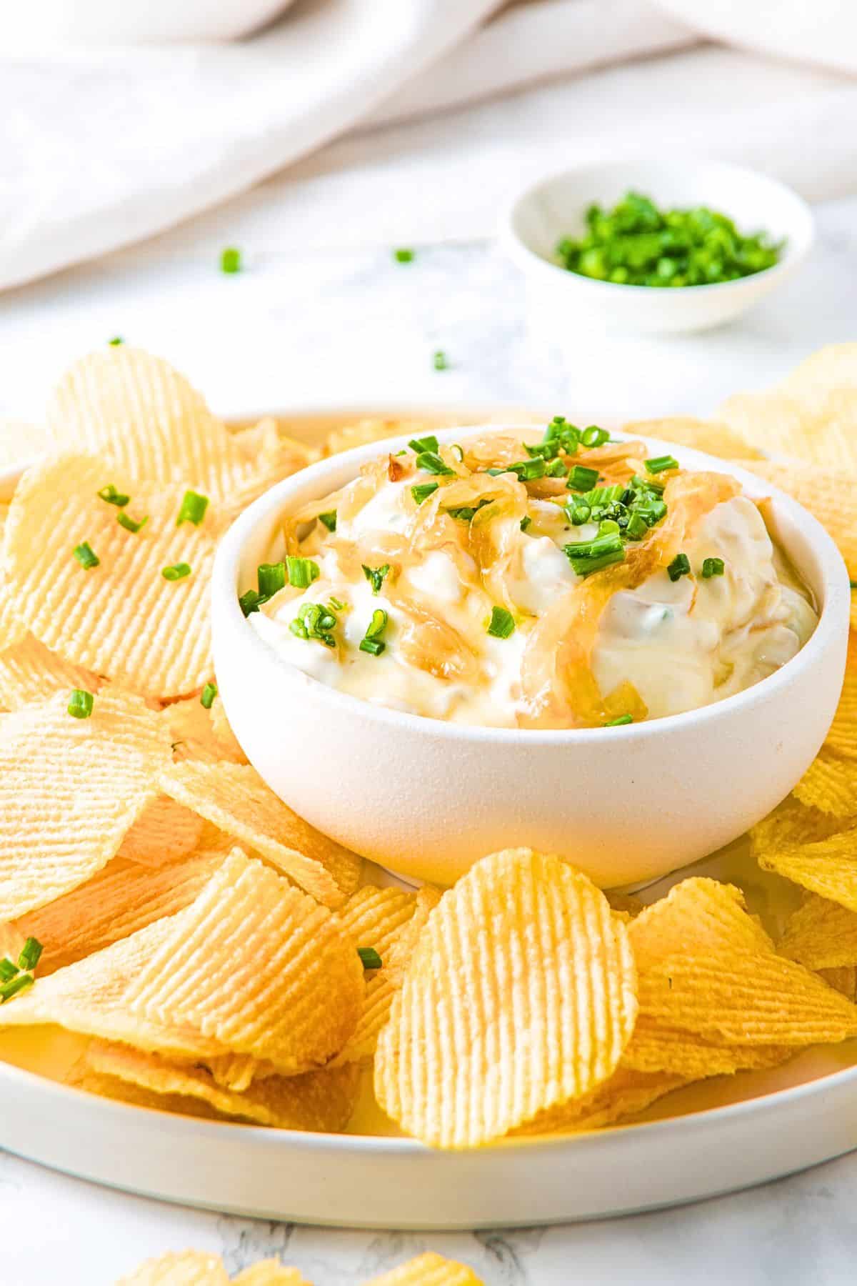 A plate of chips and onion dip.