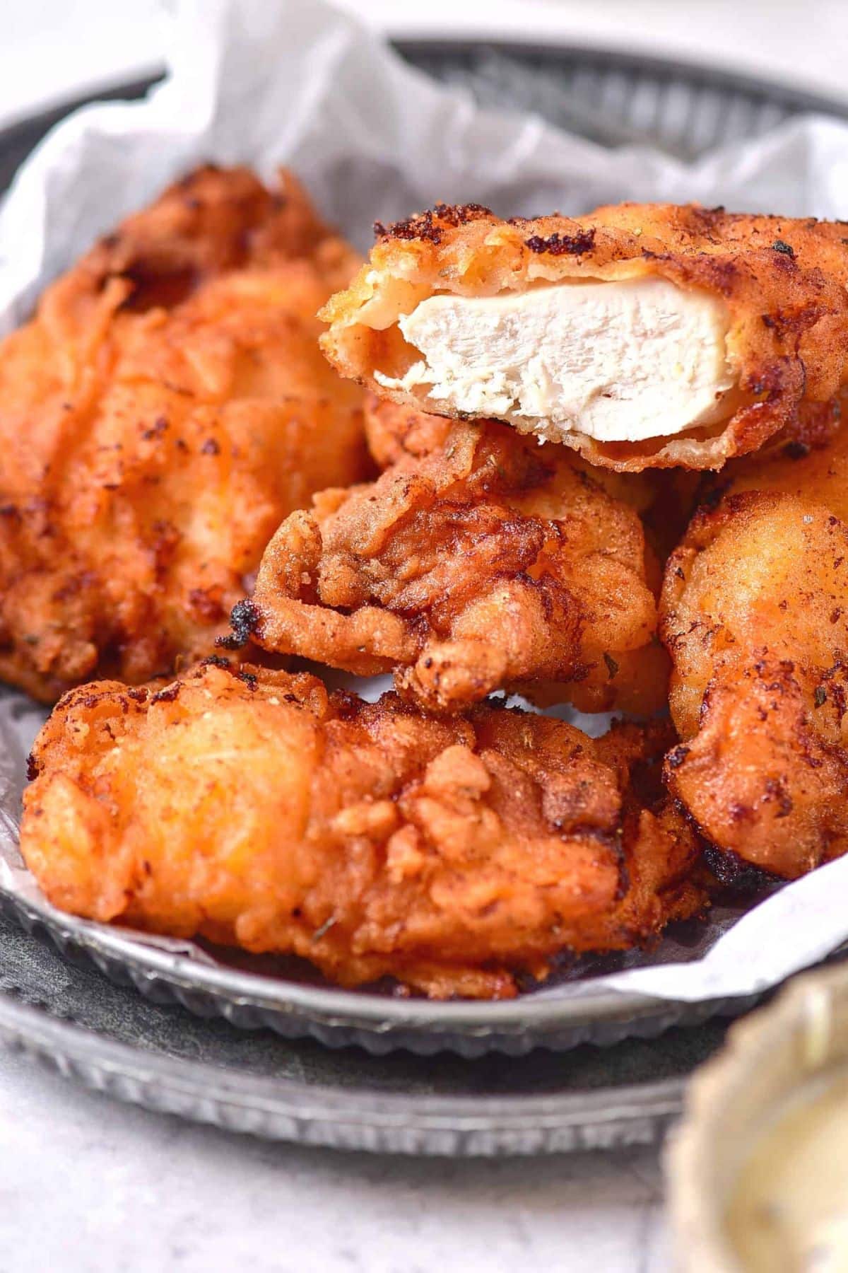 Up close shot of half-eaten gluten-free dairy-free fried chicken