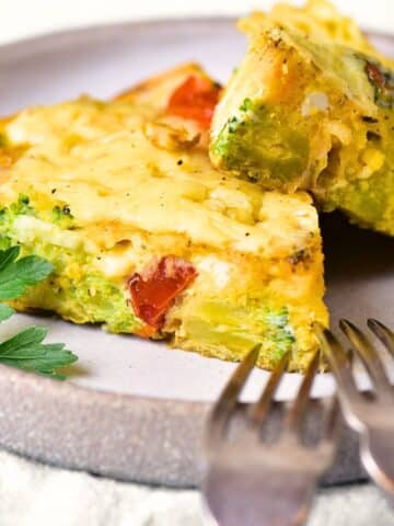 Slices of gluten-free vegetable frittata on a plate.