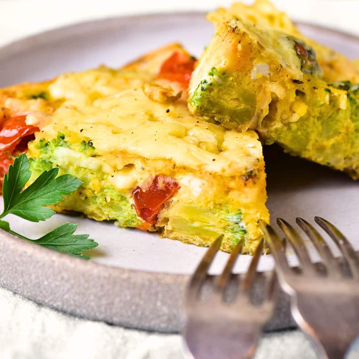 Slices of gluten-free vegetable frittata on a plate.