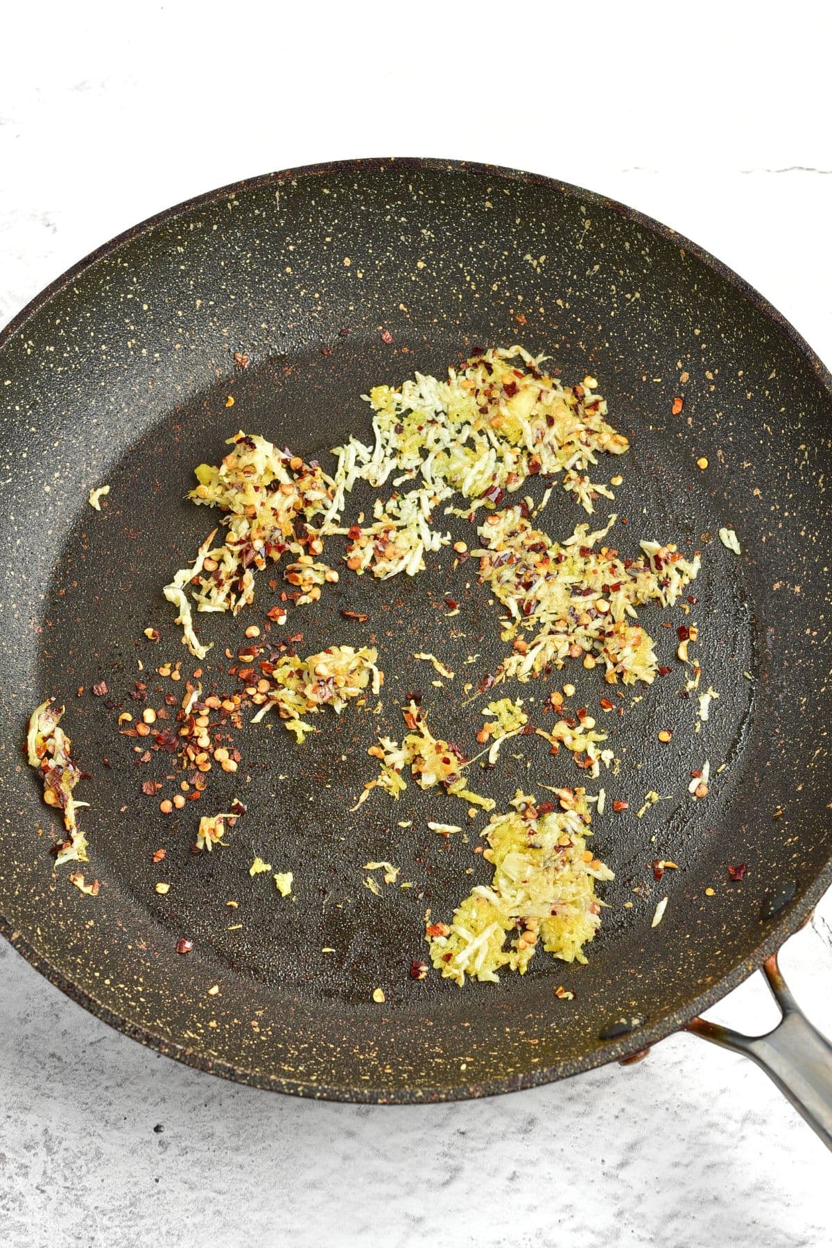 Sautéing ginger, garlic and red pepper flakes in skillet