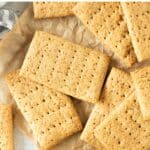 Top down view of graham crackers and a bowl of honey.