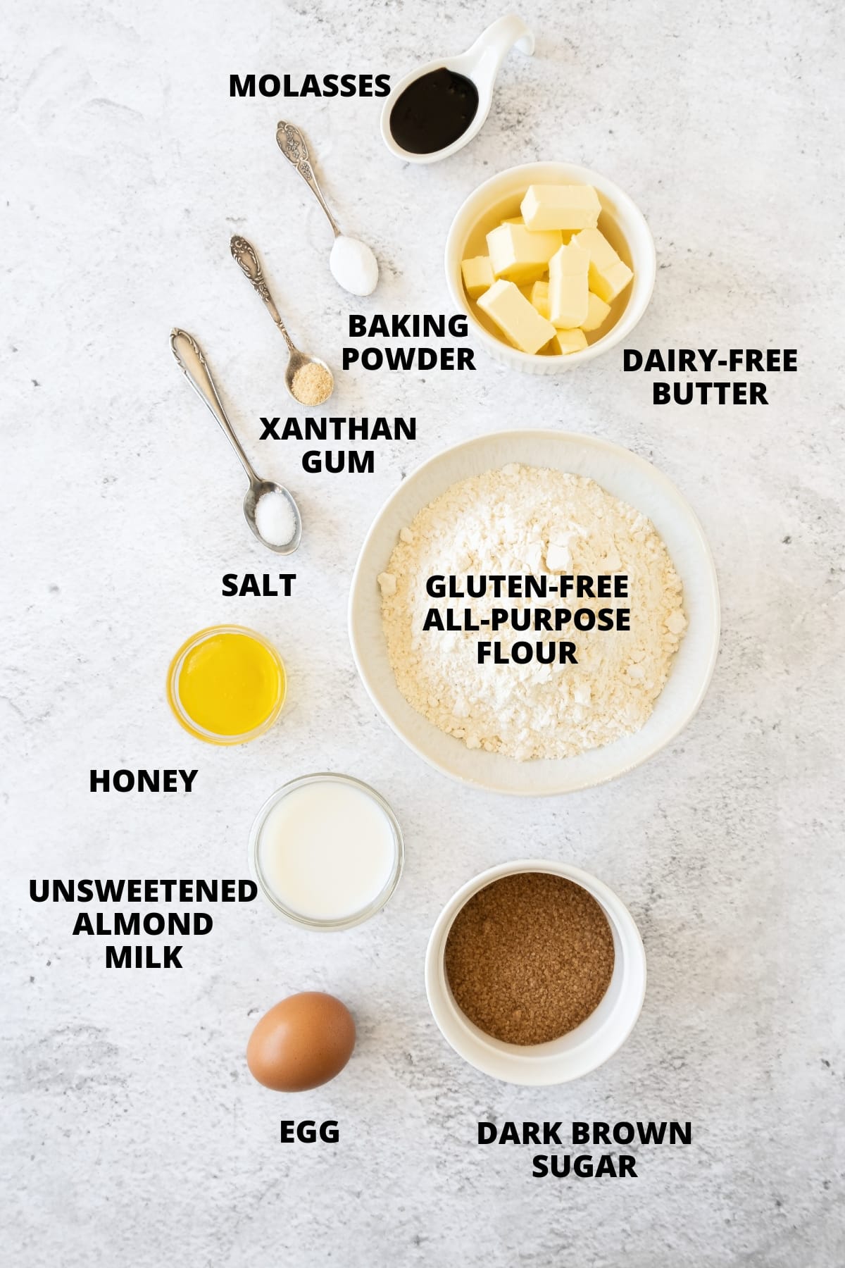 Ingredients for gluten-free graham crackers recipe laid out on board.