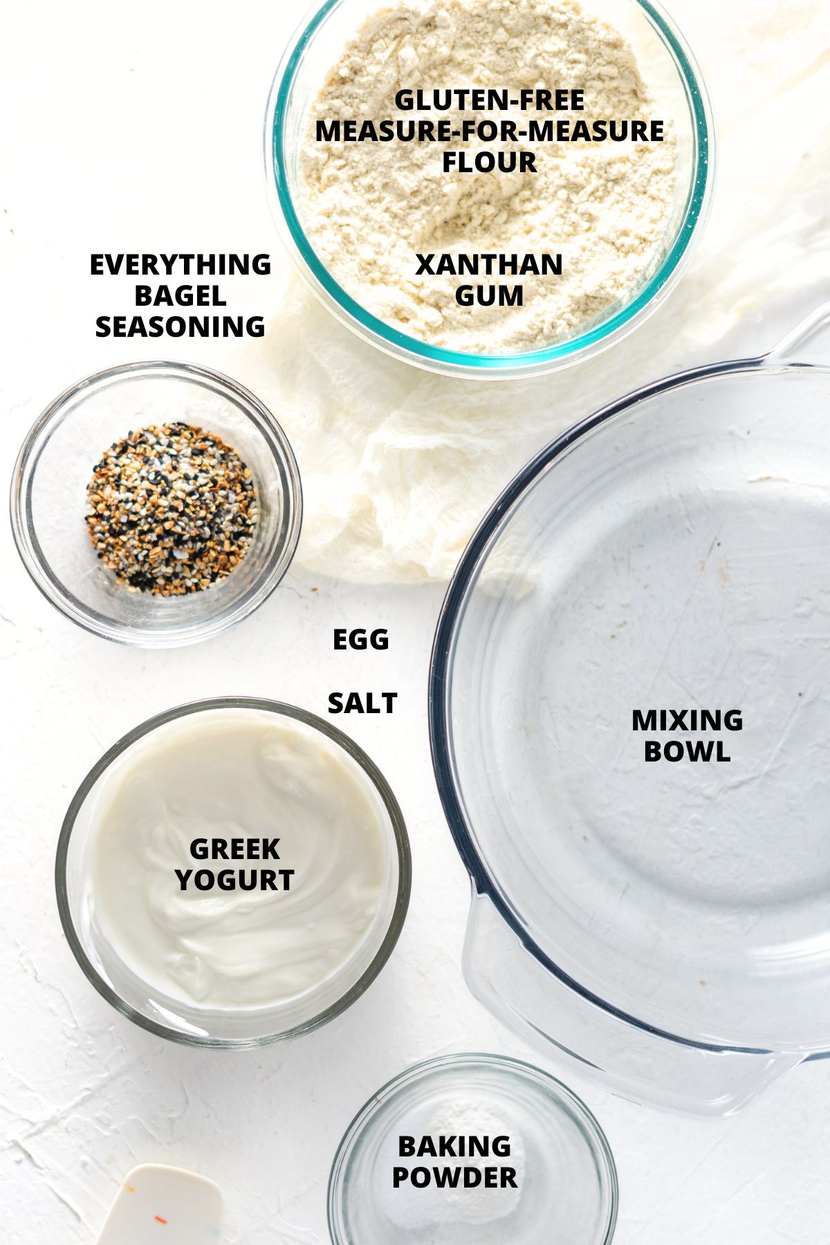 Ingredients for gluten-free Greek yogurt bagels recipe laid out on white board