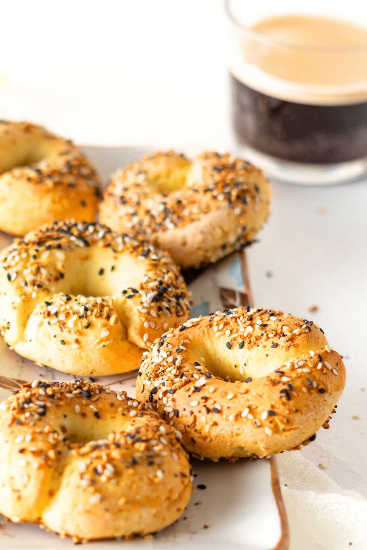 A plate of gluten-free yogurt bagels and a cup of coffee