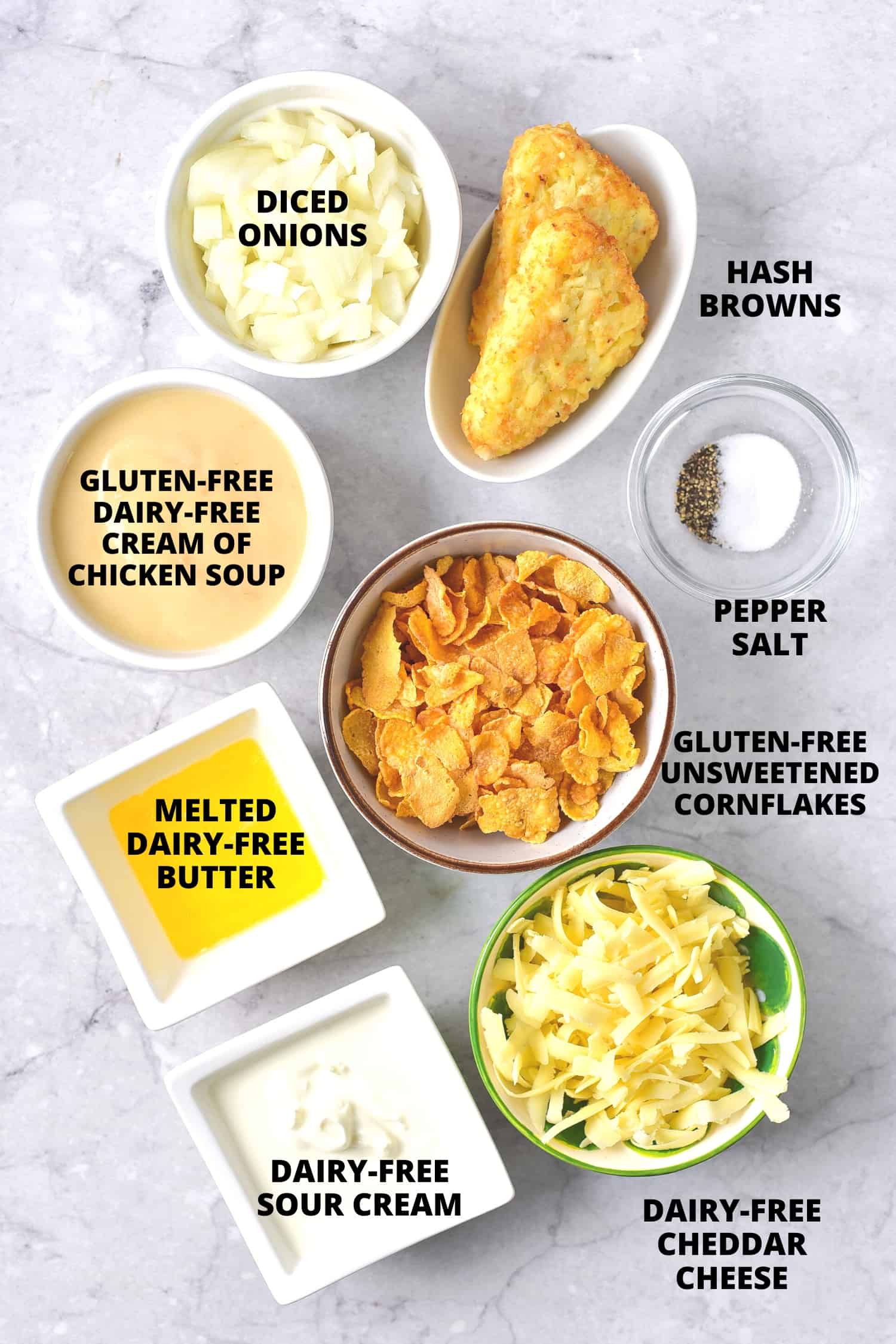 Ingredients for gluten-free hash brown casserole laid out on marble board.