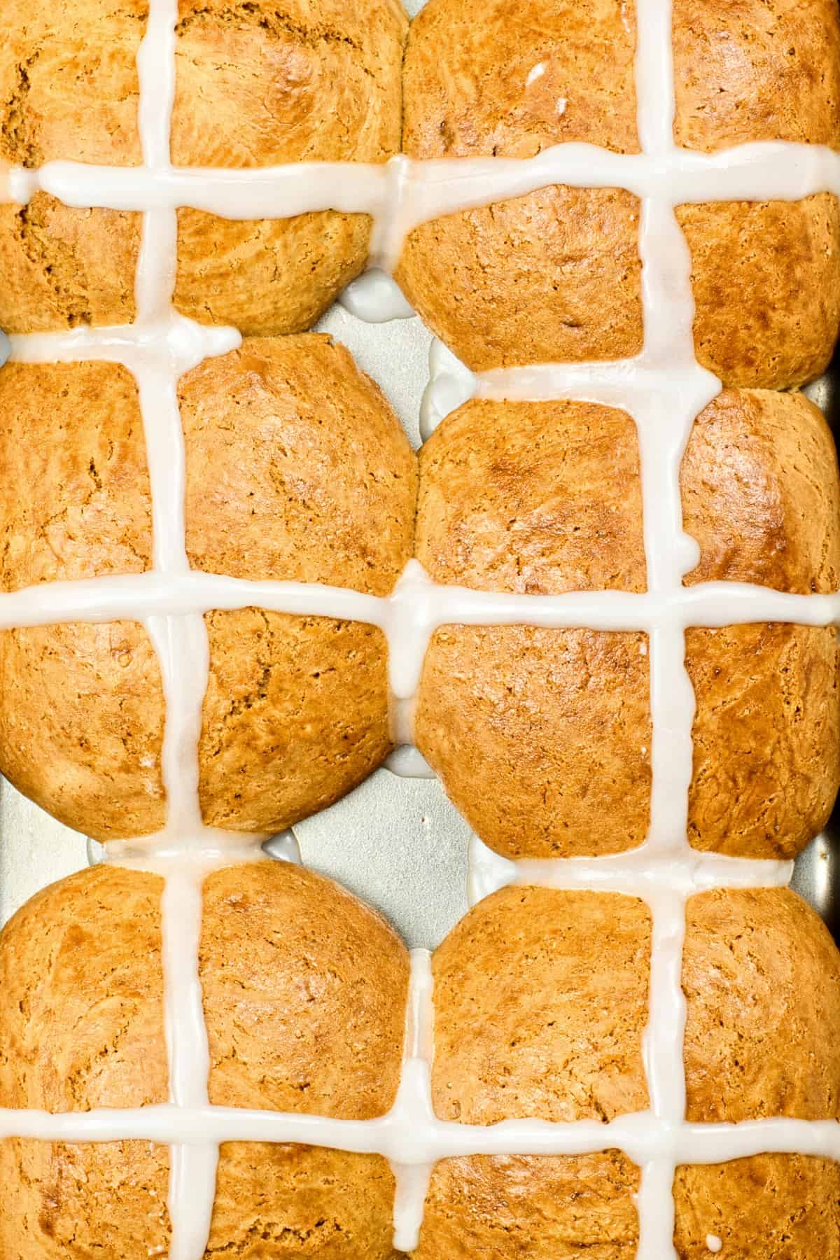 Hot cross buns in metal pan.