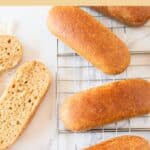 Top down view of gf hot dog buns on wire rack.