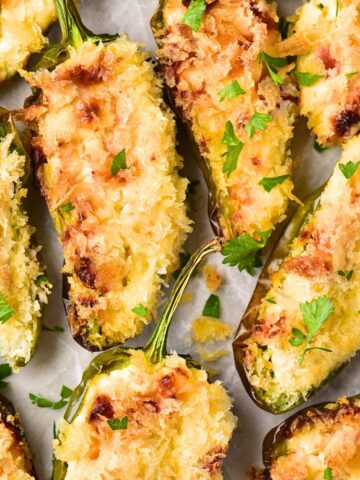 Top down view of gluten-free jalapeño poppers on parchment.