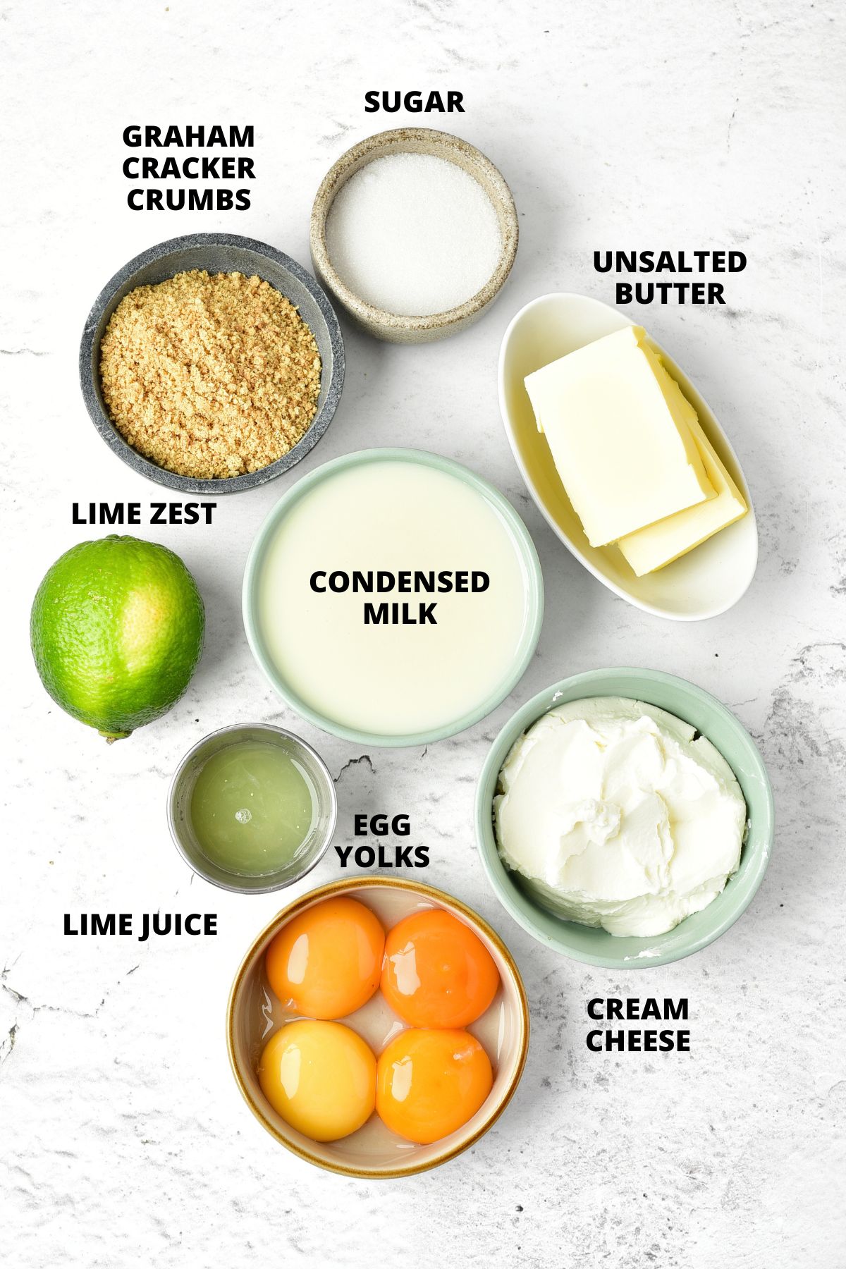 Ingredients for gluten-free key lime bars recipe laid out on marble board