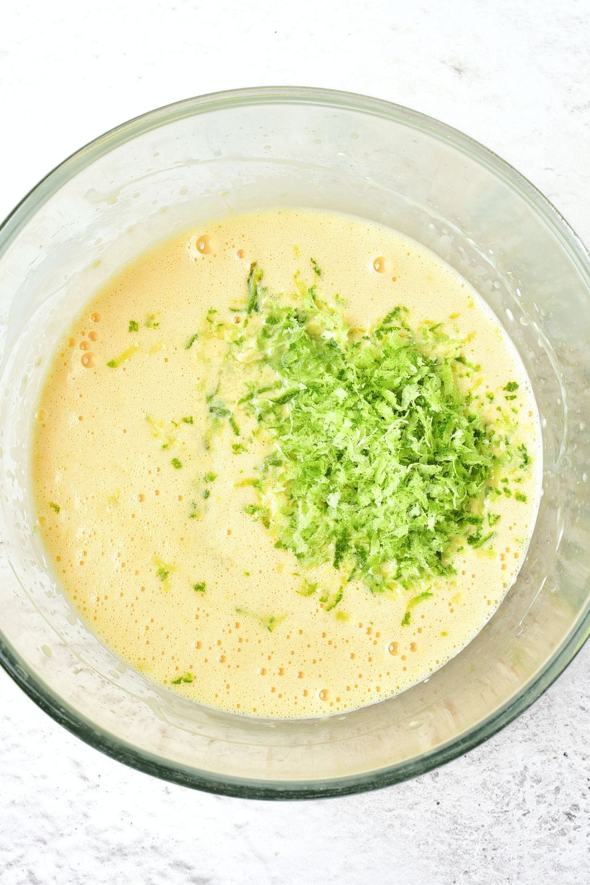 Grated lime zest on top of condensed milk