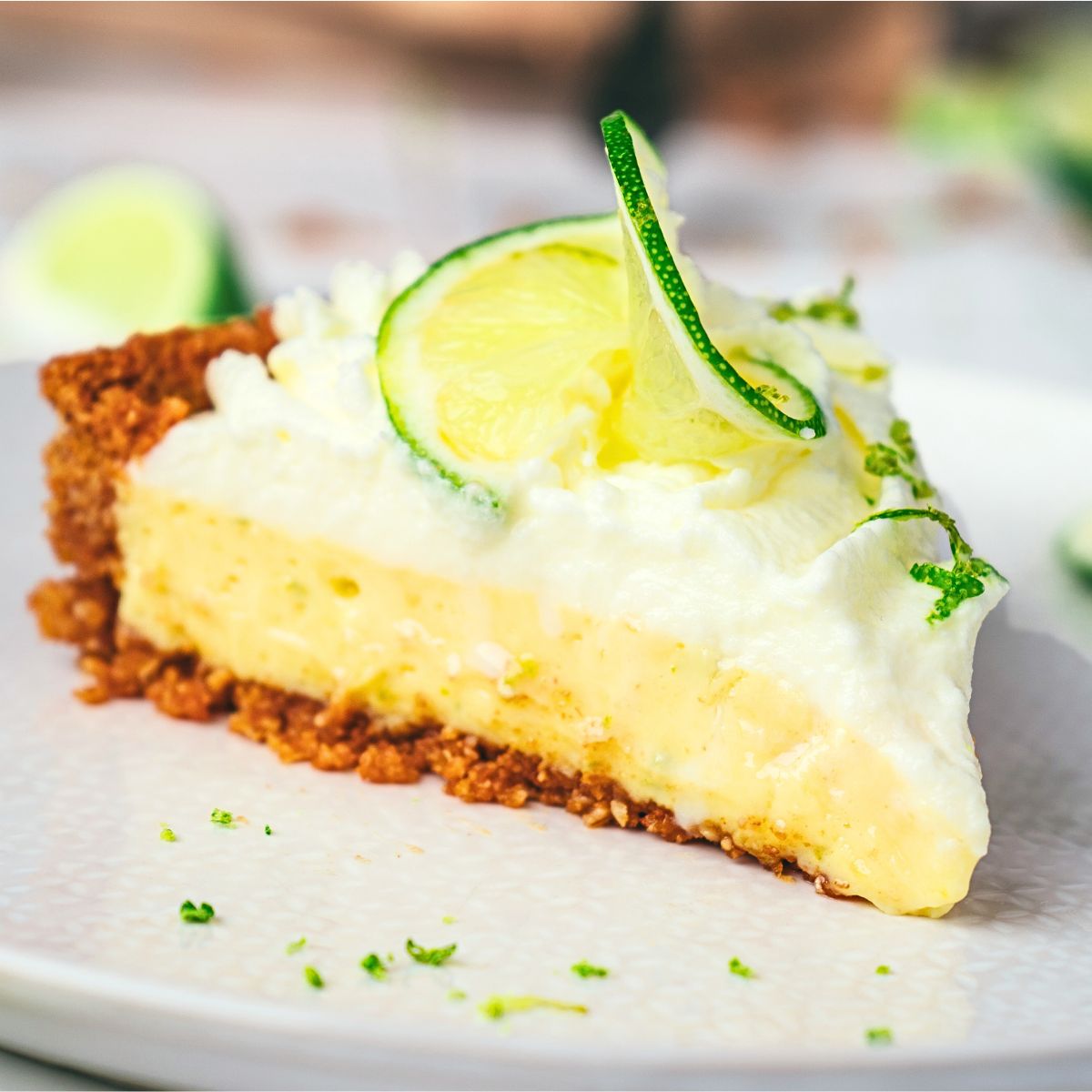 A slice of key lime pie on white plate