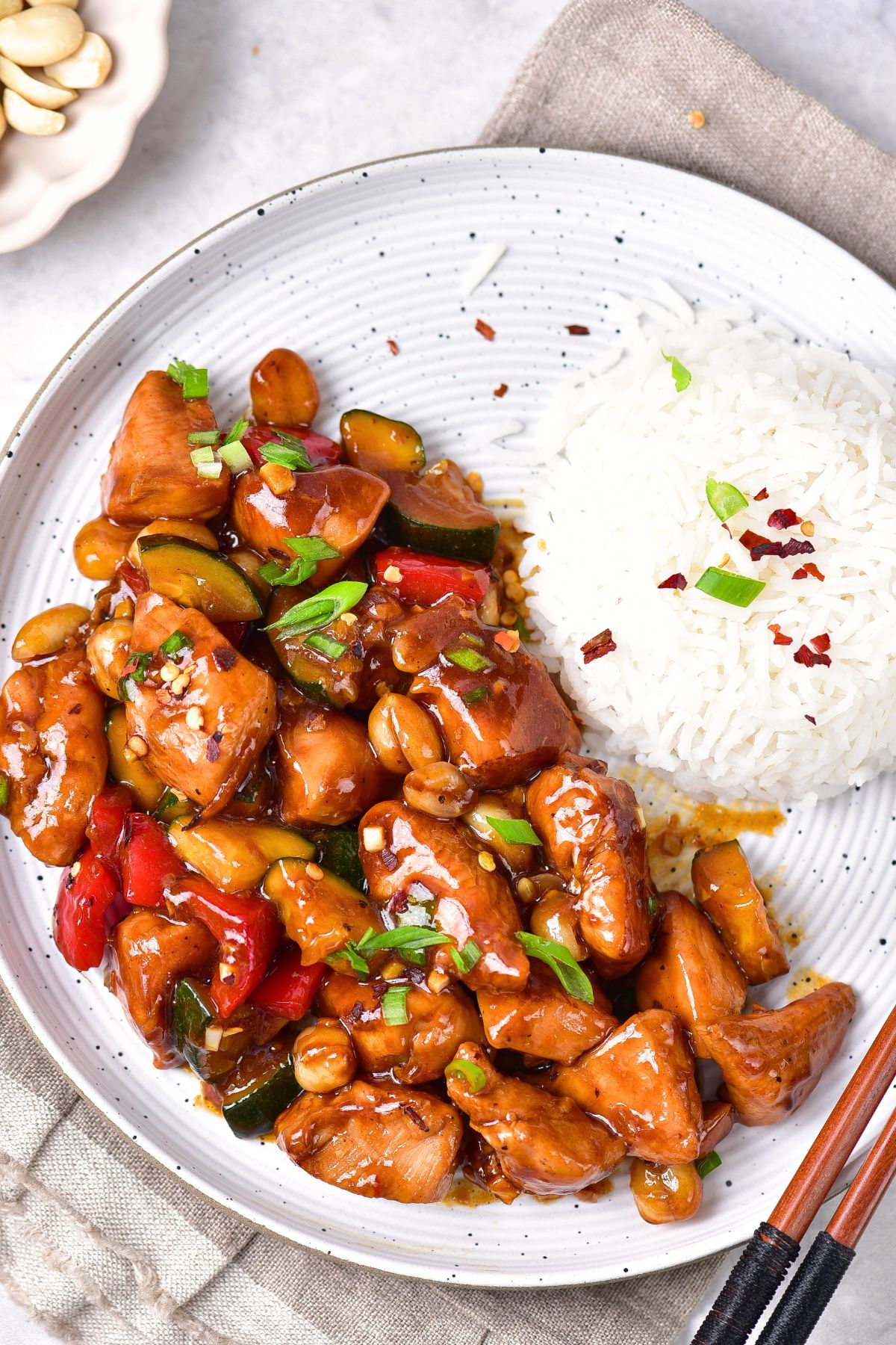 Top down view of a plate of gluten-free kung pao chicken and rice.
