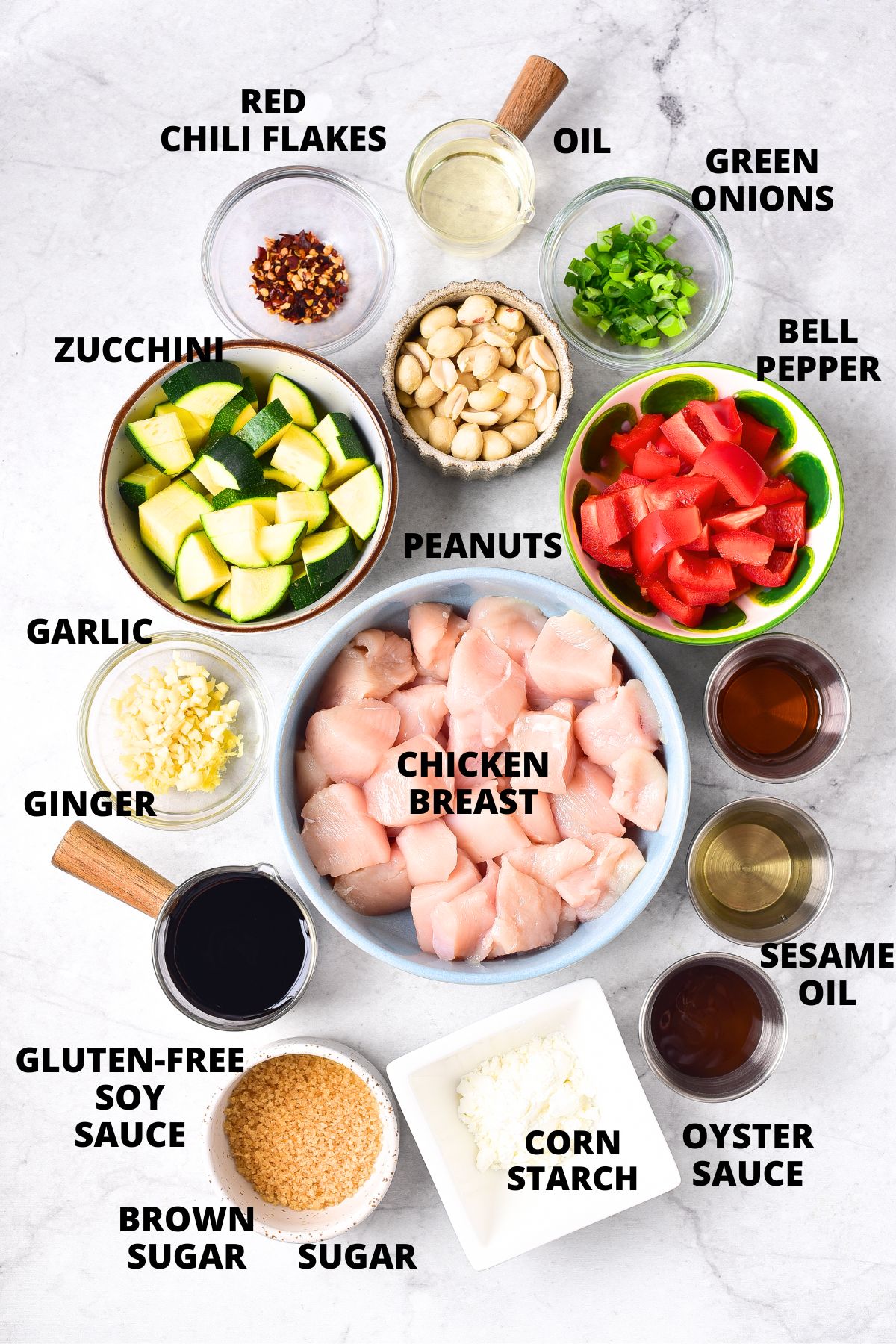Ingredients for gluten-free kung pao chicken recipe laid out on marble board.