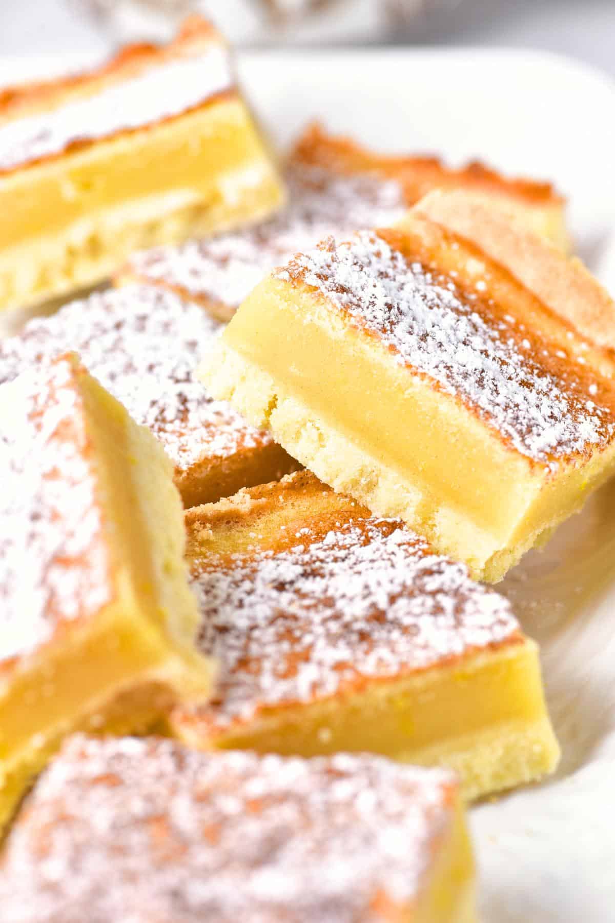 Up close shot of lemon bars sprinkled with powdered sugar.