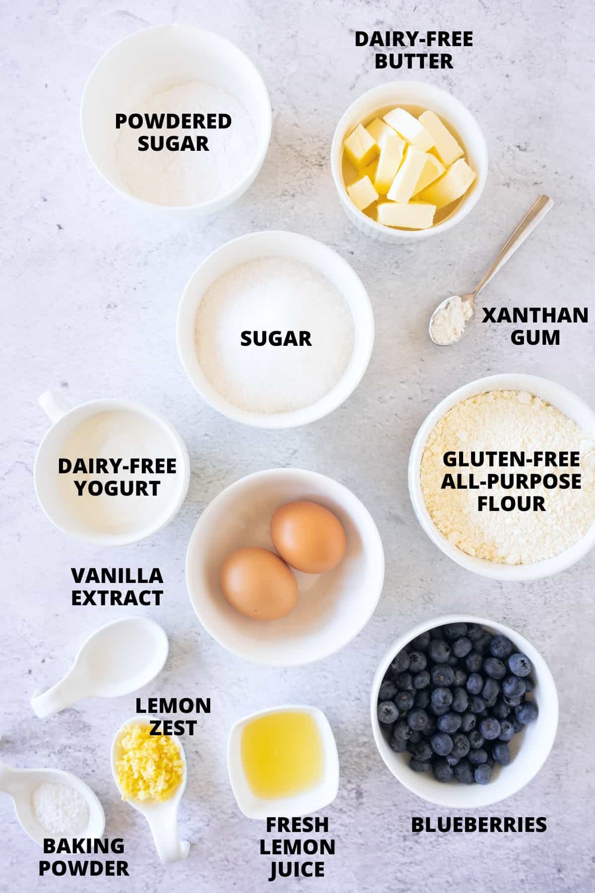 Ingredients for gluten-free dairy-free blueberry bread recipe laid out on board.