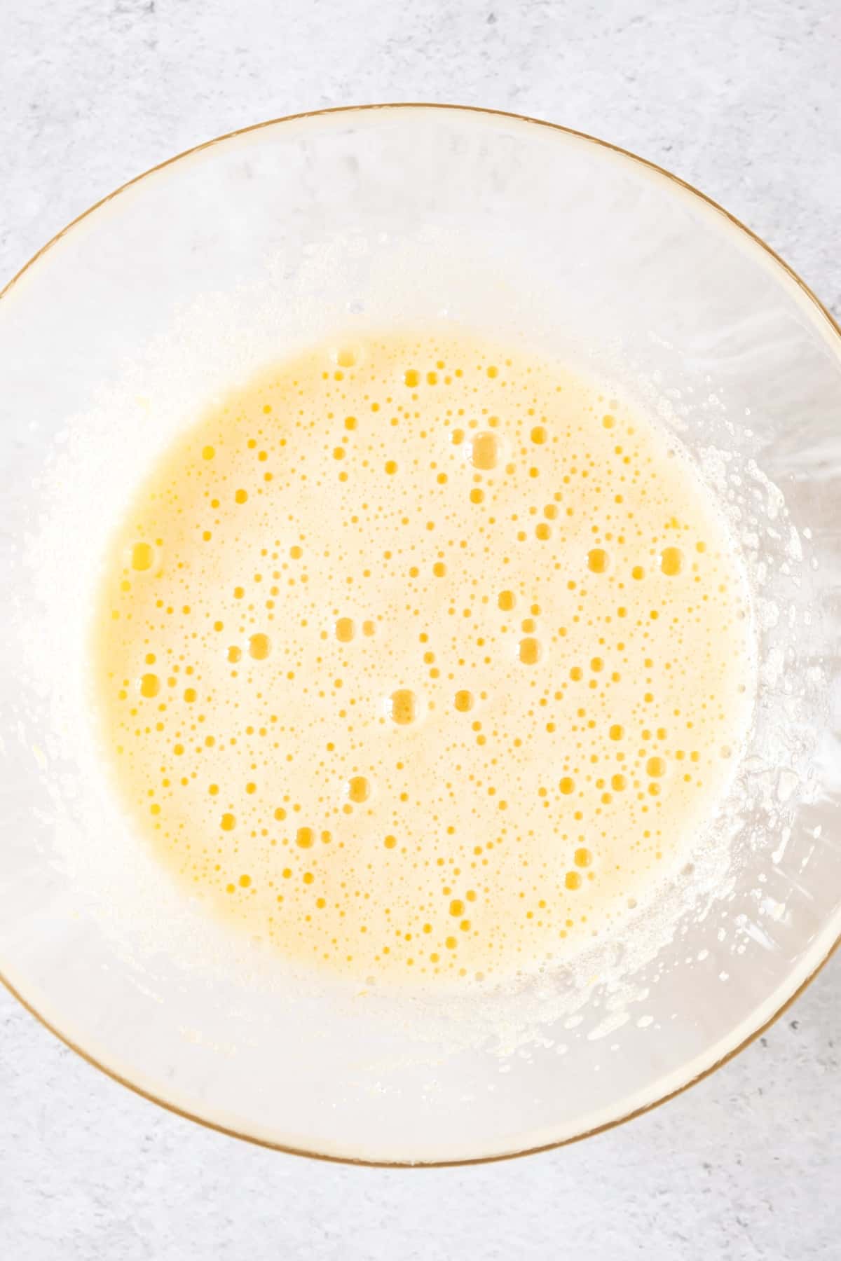 Pale yellow mixture in glass bowl.