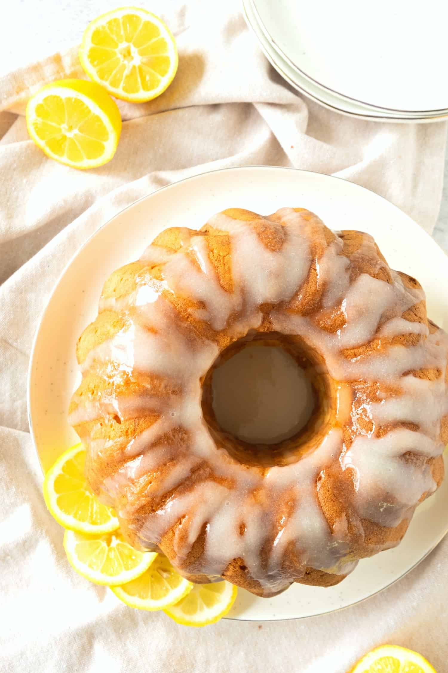 Top down view of lemon cake with lemon glaze on plate.