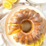 Top down view of gluten-free bundt cake on a plate with lemon slices.