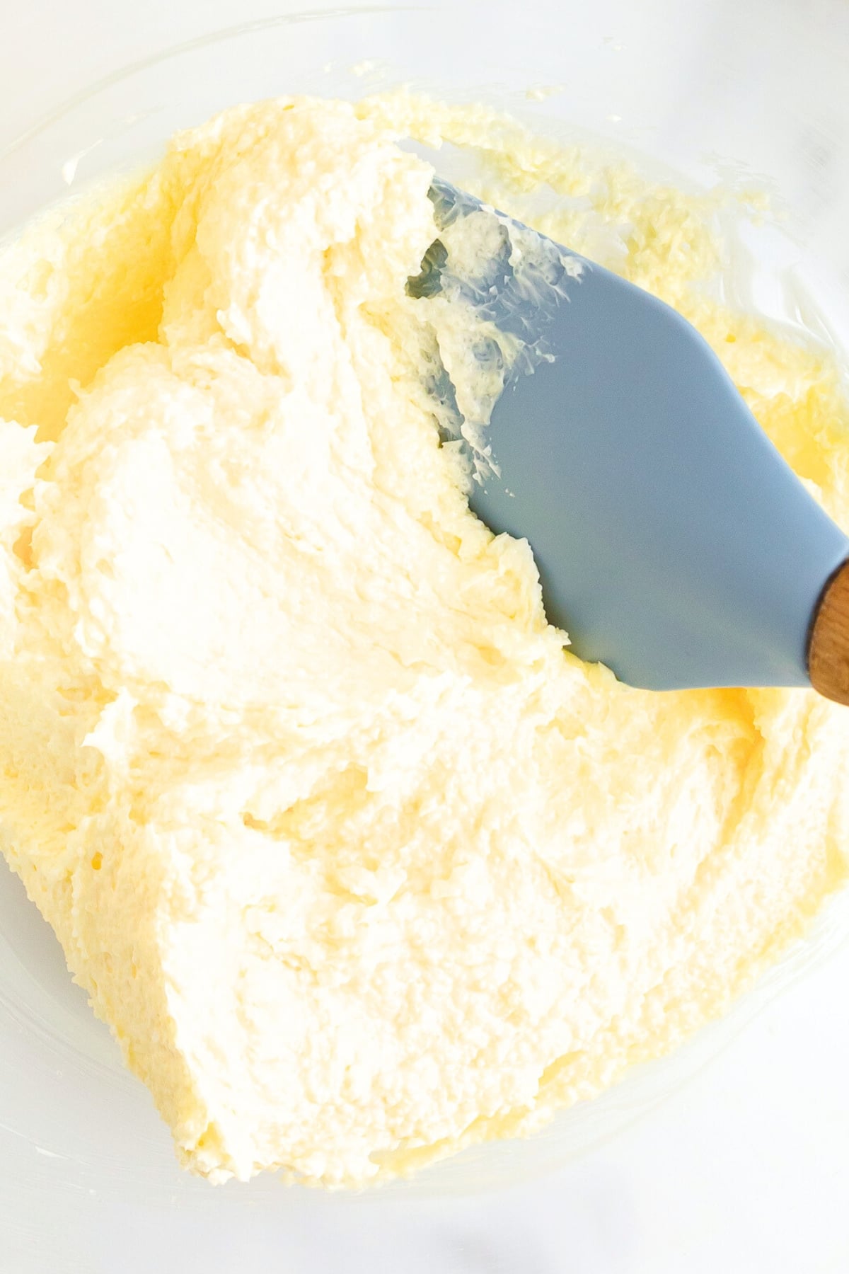 Mixing butter-sugar mixture in bowl.
