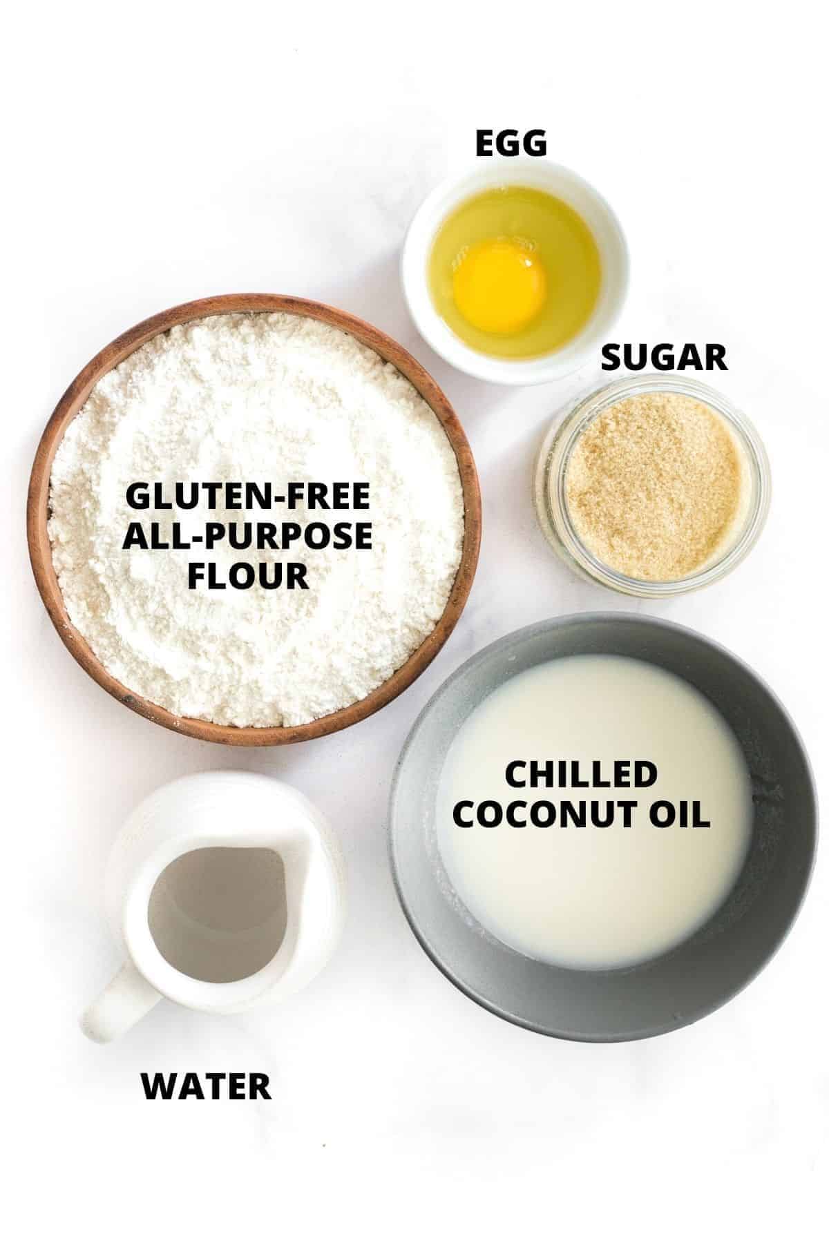Top down view of ingredients for gluten-free pie crust laid out on marble board.