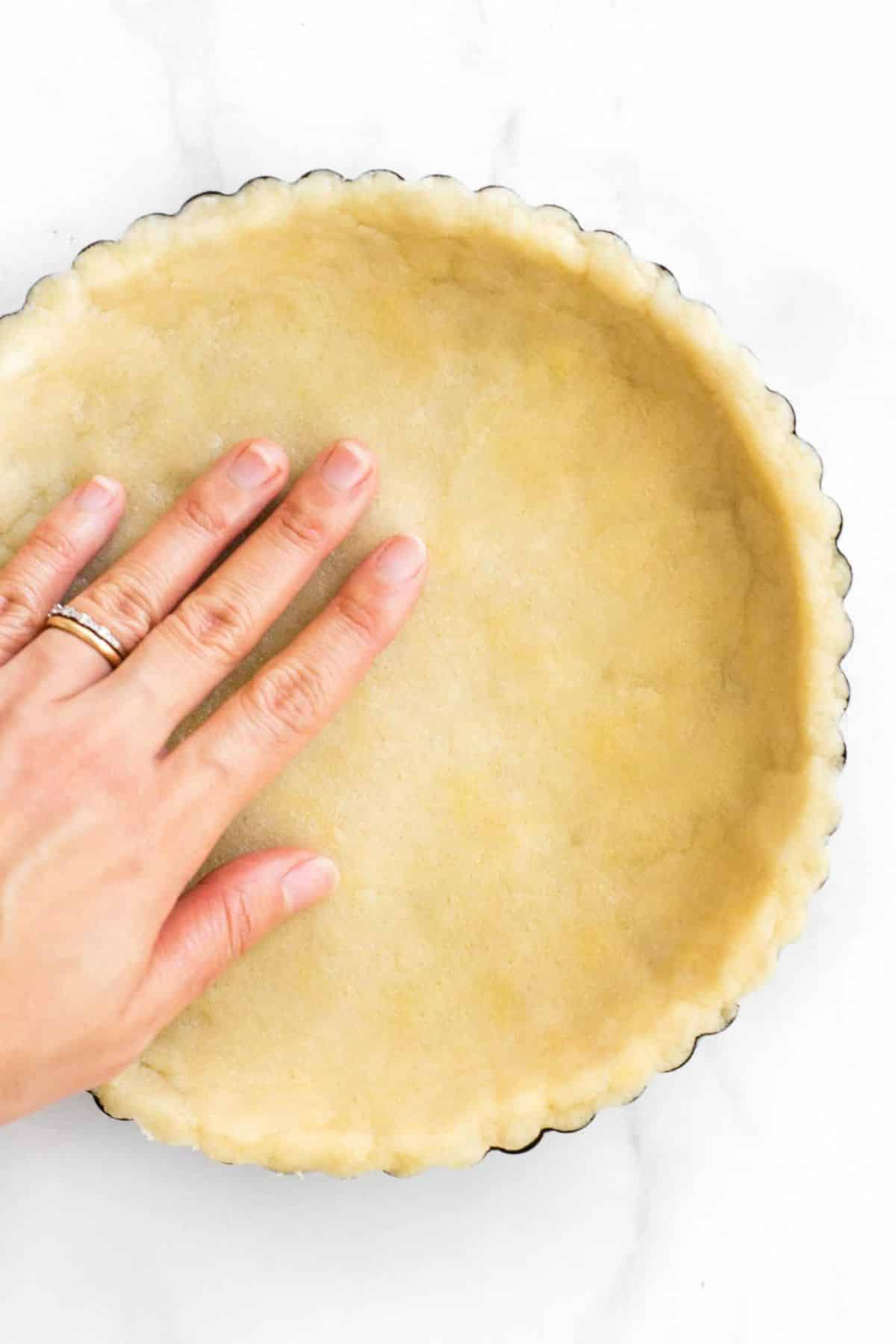 Pressing gf pie dough into pie pan.