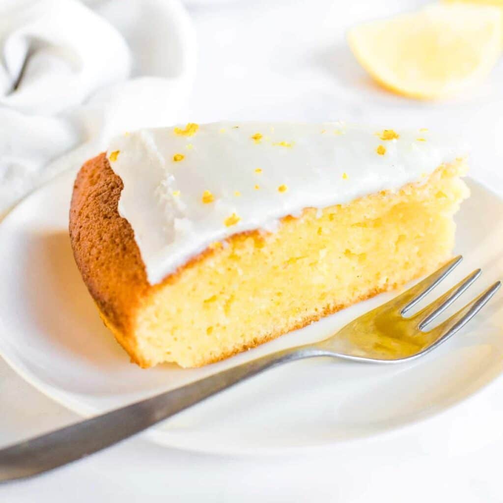 A slice of gf lemon olive oil cake on plate.