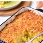 Fork in a half-eaten mac and cheese casserole.