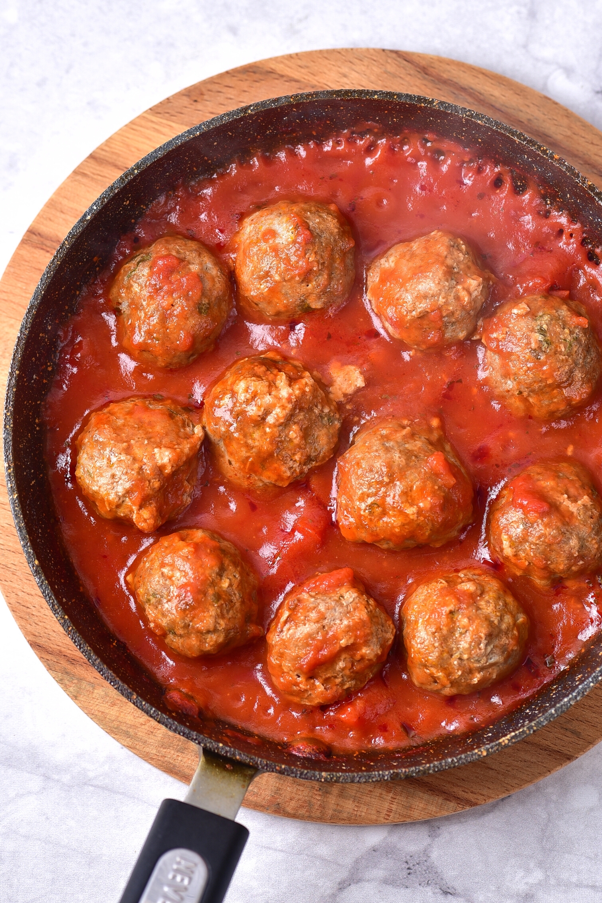 Top down view of gluten-free dairy-free meatballs in tomato sauce.