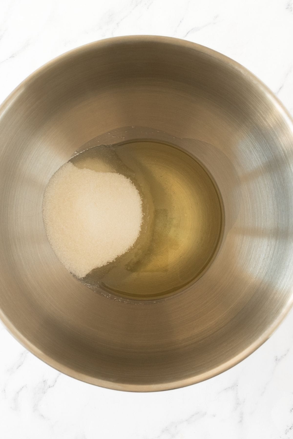 Sugar and oil in metal bowl