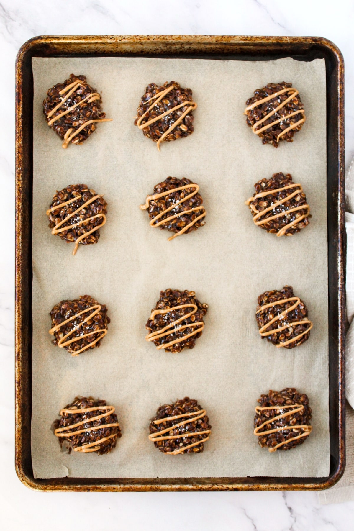 Top down view of gluten-free no bake cookies on parchment-lined tray.