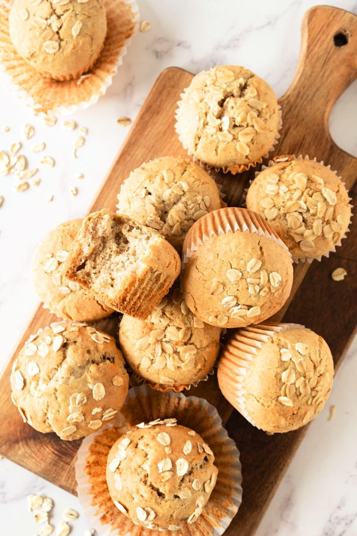 Top down view of oatmeal gluten-free muffins on wooden board.