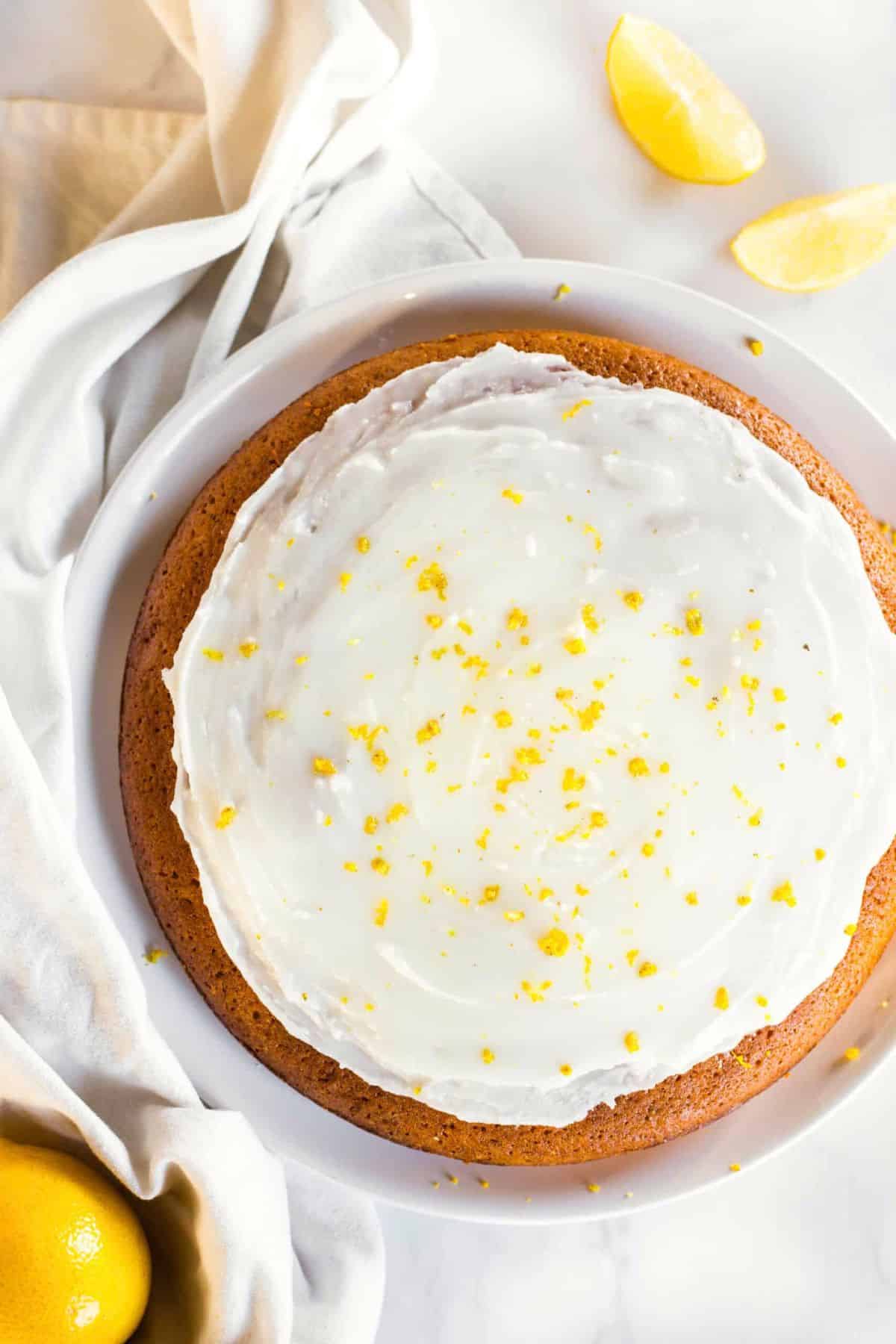 Gluten-Free Lemon Olive Oil Cake (Dairy-Free) Top down view of lemon olive oil cake with frosting.