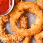 Up close shot of onion rings and chili sauce