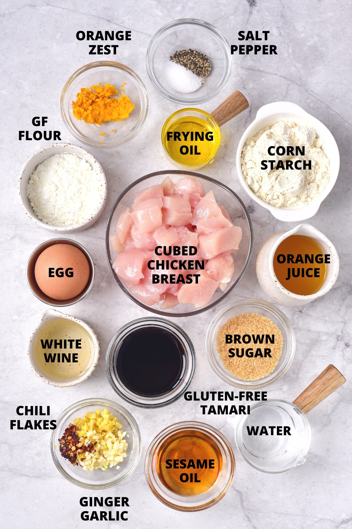 Easy Gluten-Free Orange Chicken Recipe (Dairy-Free) Ingredients for gluten-free orange chicken recipe laid out on marble board.