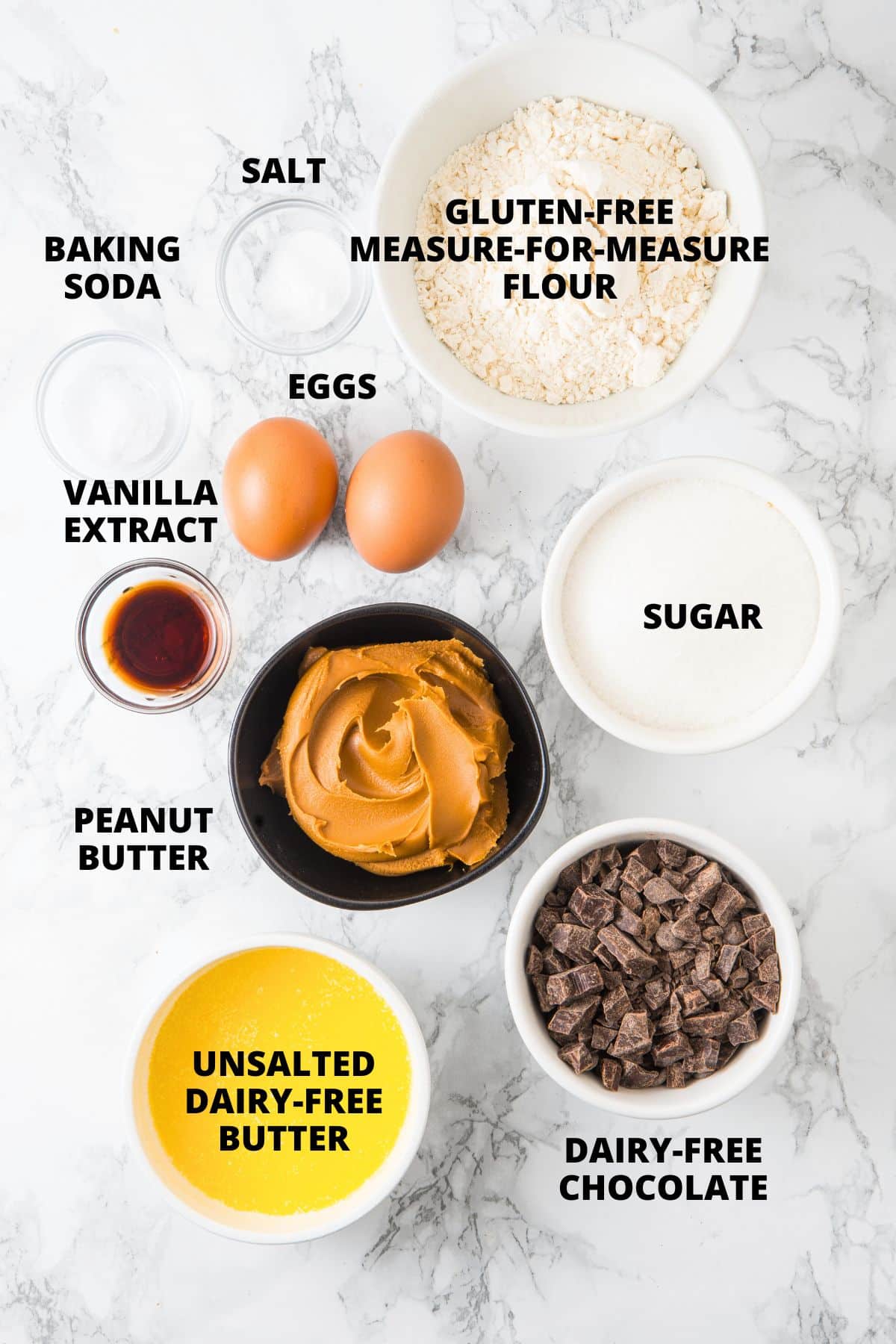 Ingredients for gluten-free peanut butter brownies recipe laid out on marble board.