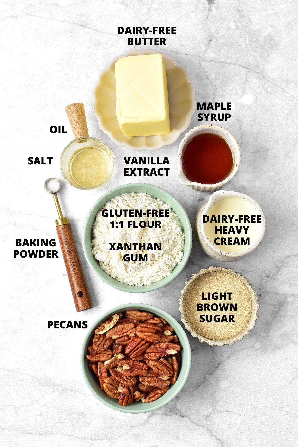 Ingredients for gluten-free pecan pie bars recipe laid out on marble board.