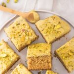 Top down view of a plate filled with squares of pistachio cake